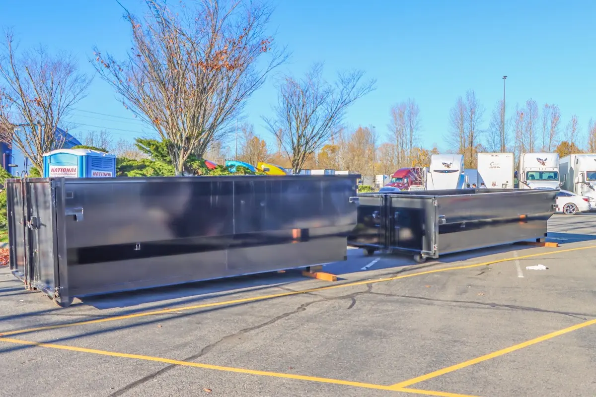 Professional dumpster rental service with roll-off container on residential driveway in Lancaster